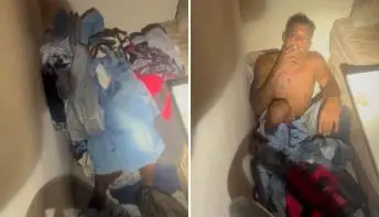 Fumando, ladrão é encontrado se escondendo atrás de roupas na cena do crime