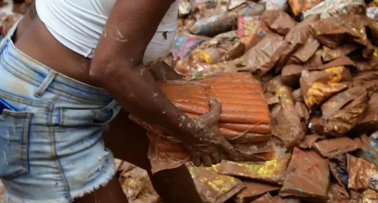 Moradores procuram alimentos em meio à sujeira de lama causada pela chuva